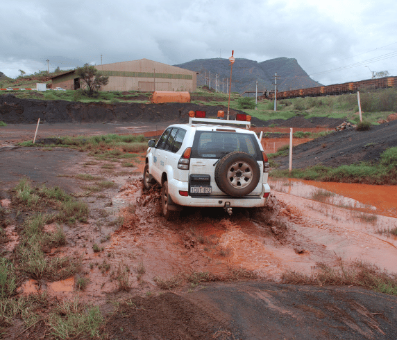 4WD traveling through a mud ditch as a example of the 4WD training course aspects delivered by Saferight.