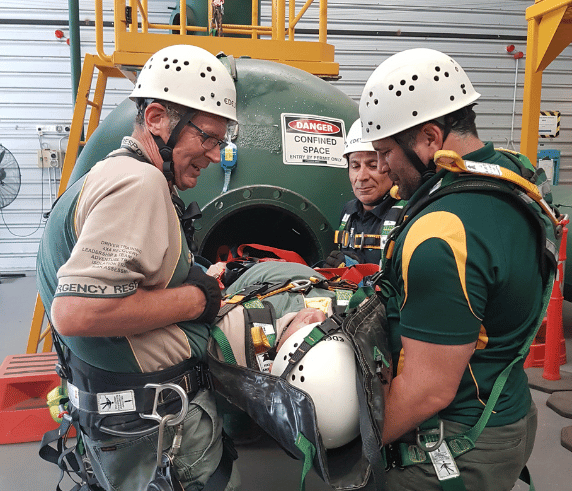 Three Saferight instructors demonstrating a Confined space entry for the Confined space entry course at Saferights training facility in Perth.