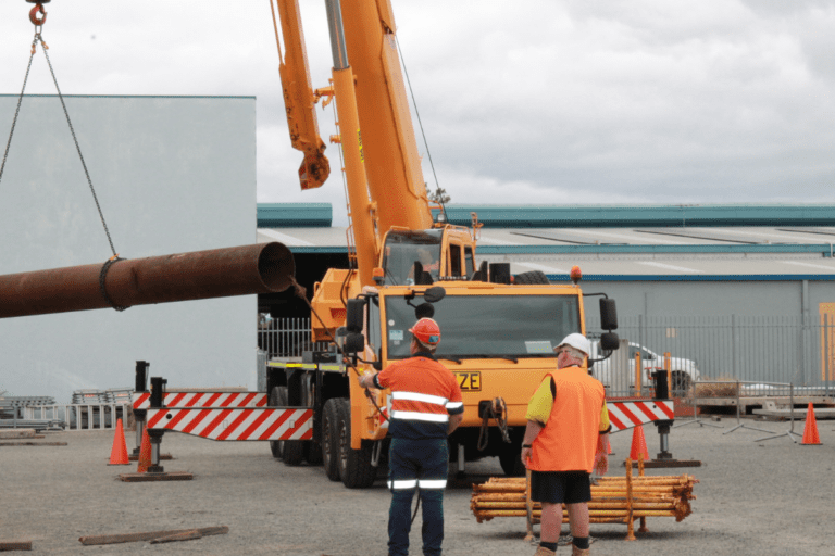 Dogging Course Perth WA. A Saferight Dogging course trainee and Saferight Dogging course instructor moving a large metal tube at Saferight facility.