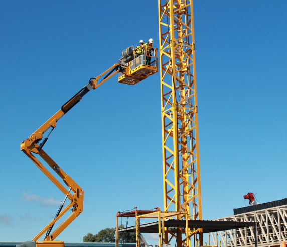 Elevating Work Platform (EWP) -Two workers operating an elevating work platform next to a construction site tower crane