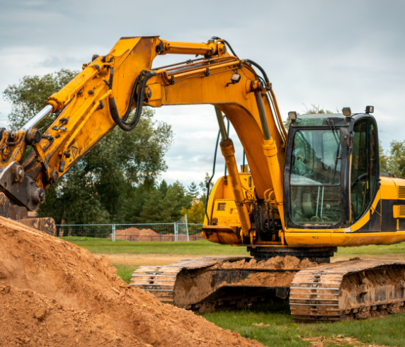 conduct hydraulic excavator operations. Yellow hydraulic excavator in action, digging through soil on a construction site