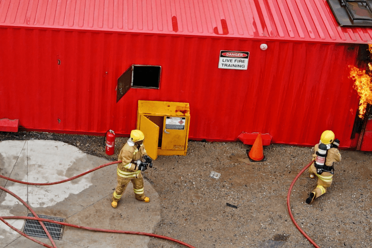 Saferight Fire Safety course trainees extinguishing an building fire drill at the Saferight fire safety facility.