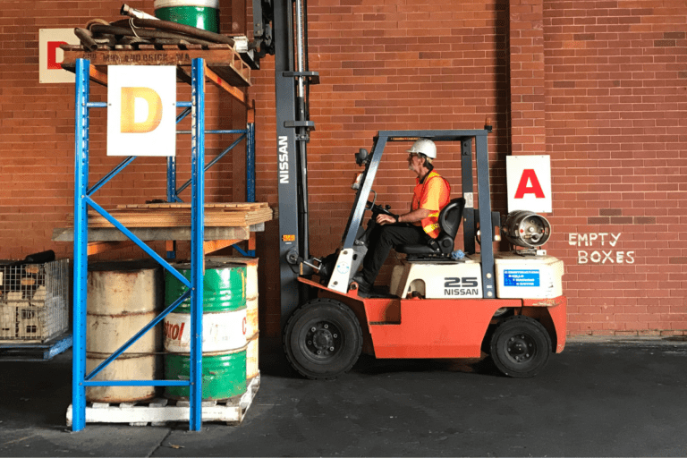 Saferight Forklift Truck operation course trainee moving a pallet from a high storage shelf.