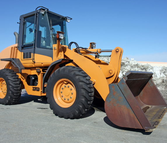 Conduct Civil Construction Wheeled Front End Loader Operations. Orange wheeled front-end loader with a large bucket, ready for operation on a civil construction site