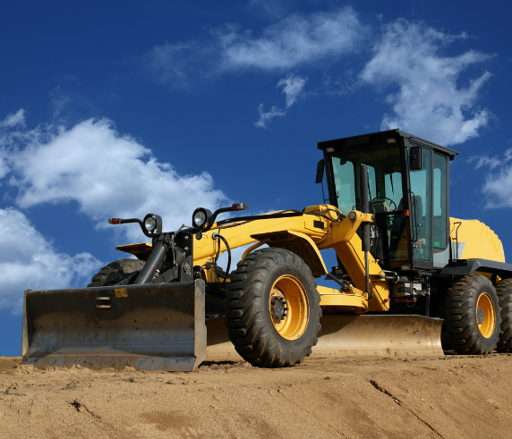 Conduct Civil Construction Grader Operations. A grader on a construction site with a blue sky background.