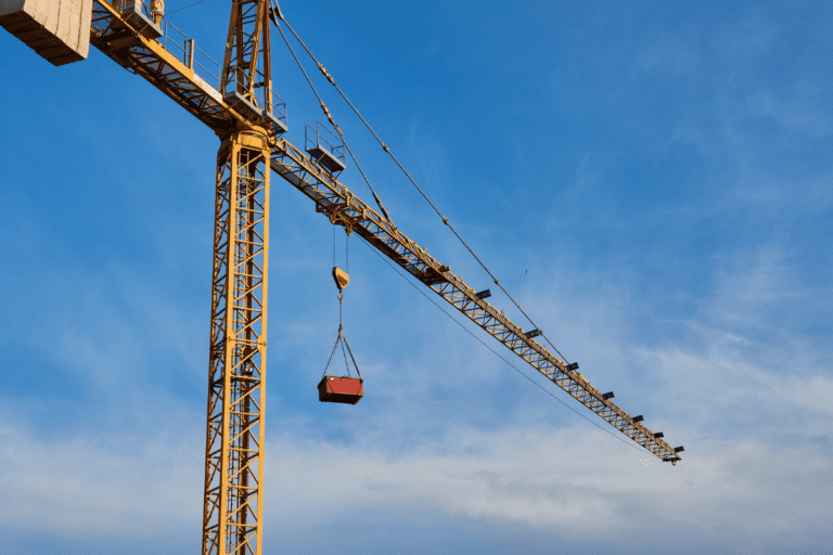 Tower crane lifting a load against a clear blue sky during Saferight's Tower Crane operation training