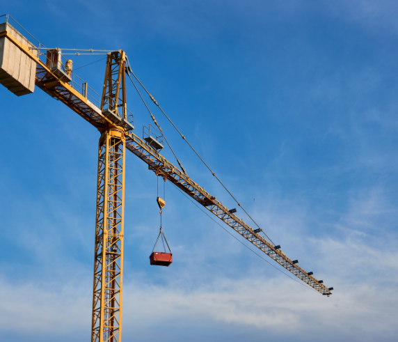 Tower crane lifting a load against a clear blue sky during Saferight's Tower Crane operation training