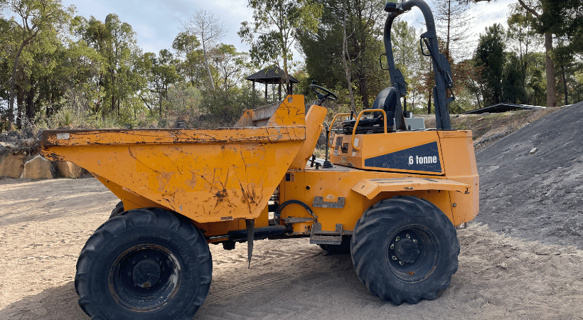 Yellow articulated dump truck in the training field. Students use this articulated dump truck in the Dump Truck Training course in Perth WA - Earning their Dump Truck Ticket 