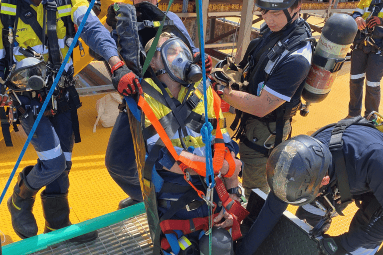 Emergency response team conducting a vertical rescue exercise with a fully harnessed person at Saferight's training facility