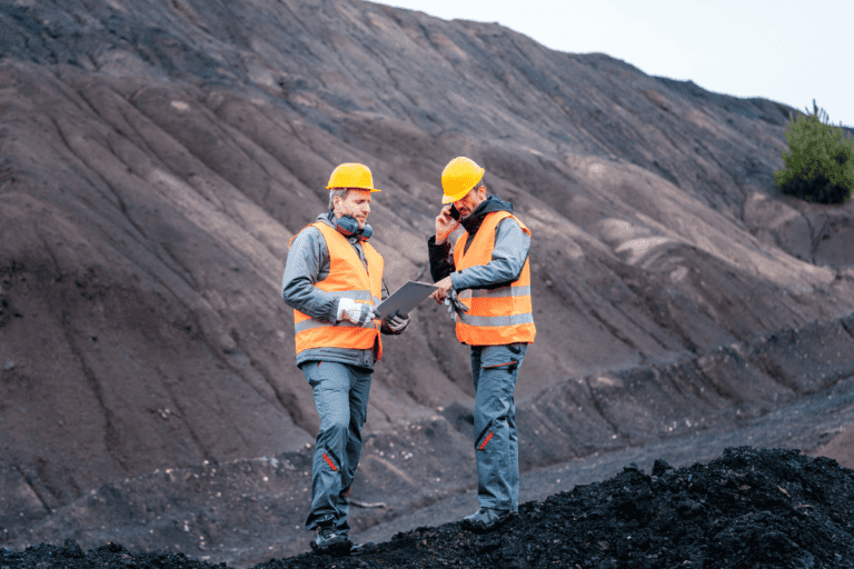 Site Senior Executive WHS Risk Management. Two safety professionals conducting a field assessment in a mining environment.