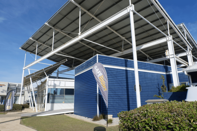 Saferight Fremantle training facility front building with blue walls and Saferight flag at the front.