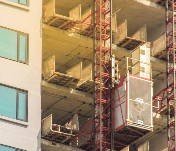 Materials hoist attached to the side of a construction building