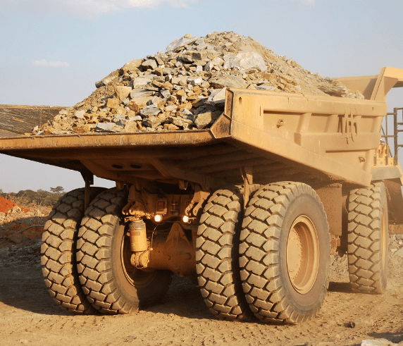 a yellow rigid haul truck on a dusty construction site