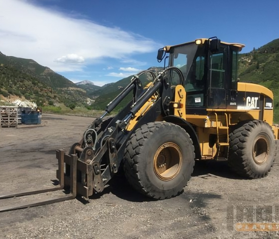 An integrated tool carrier earthmoving machine on a mine site and dirt ground.