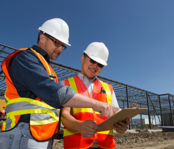 Two construction workers in PPE reviewing site safety checklist – promoting Health and Safety Representative training in Perth